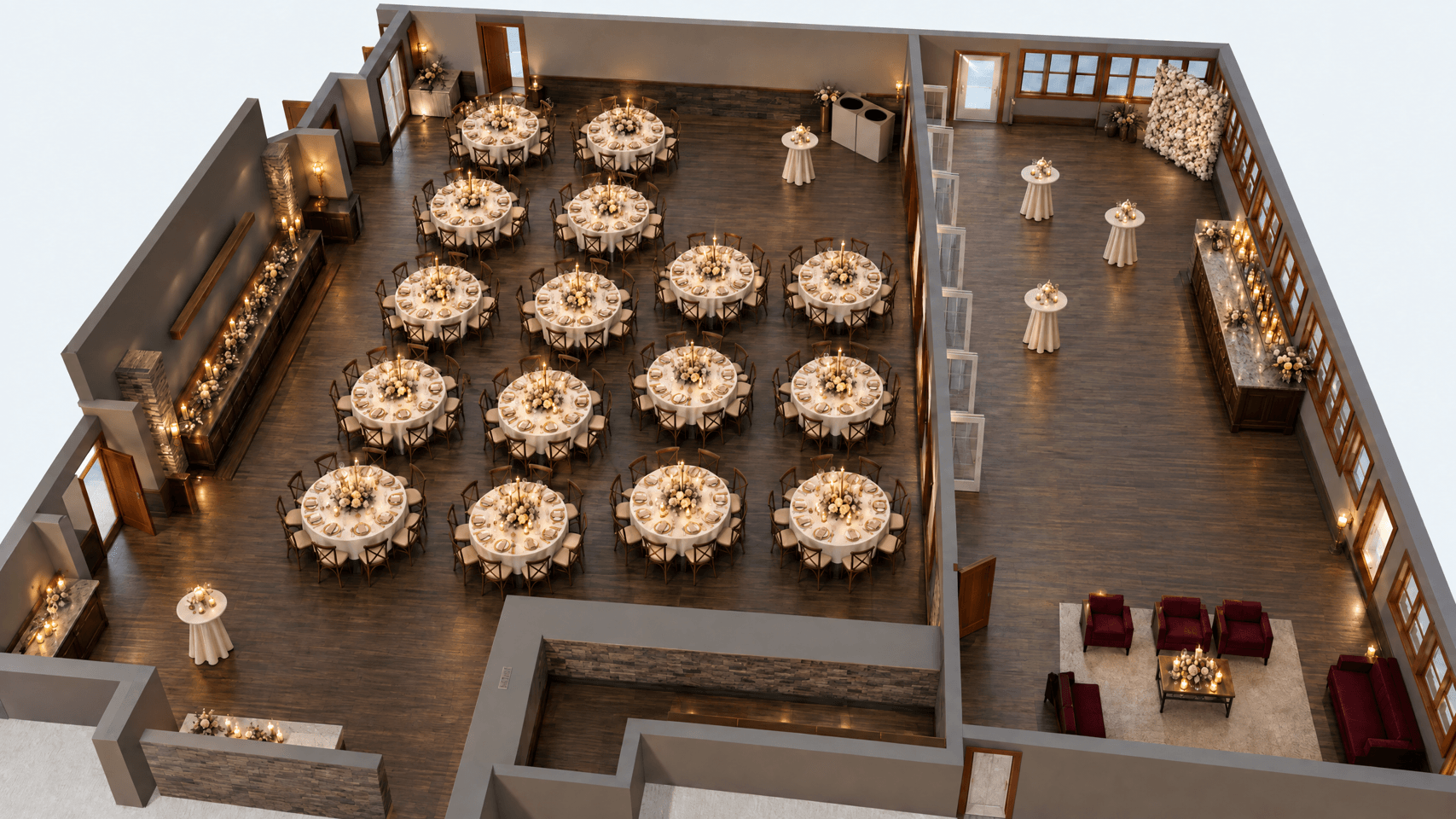 River Park set for a wedding reception, seen from above: sixteen round tables dressed with flowers and candles, and cocktail tables and a lounge beyond a wall of glass doors.